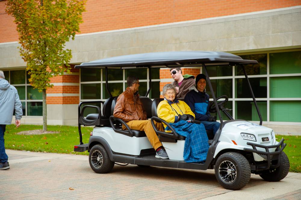 people smiling from golf cart